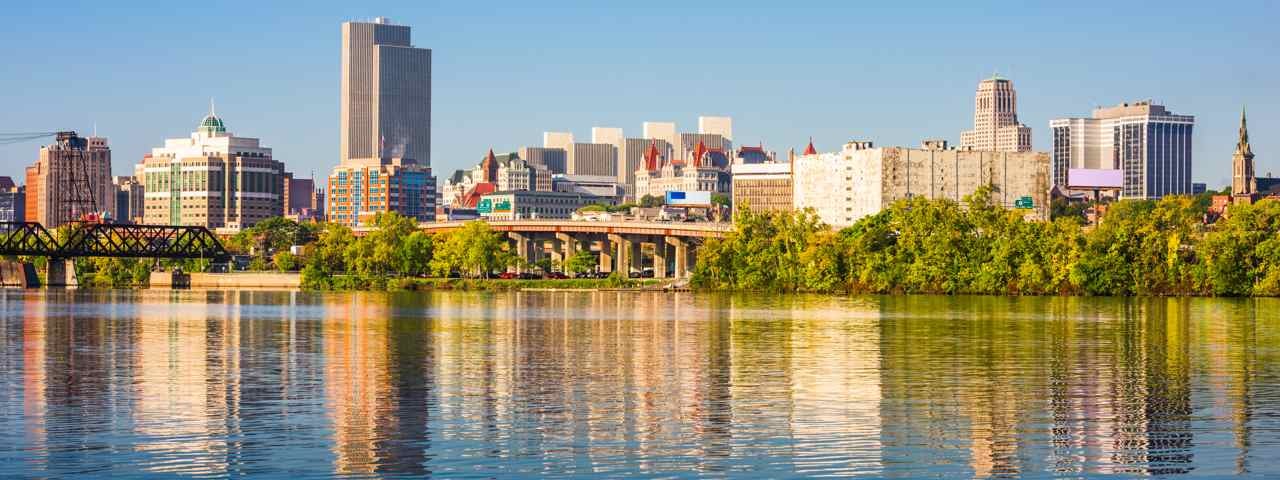 The skyline of Albany from across the water on a sunny day