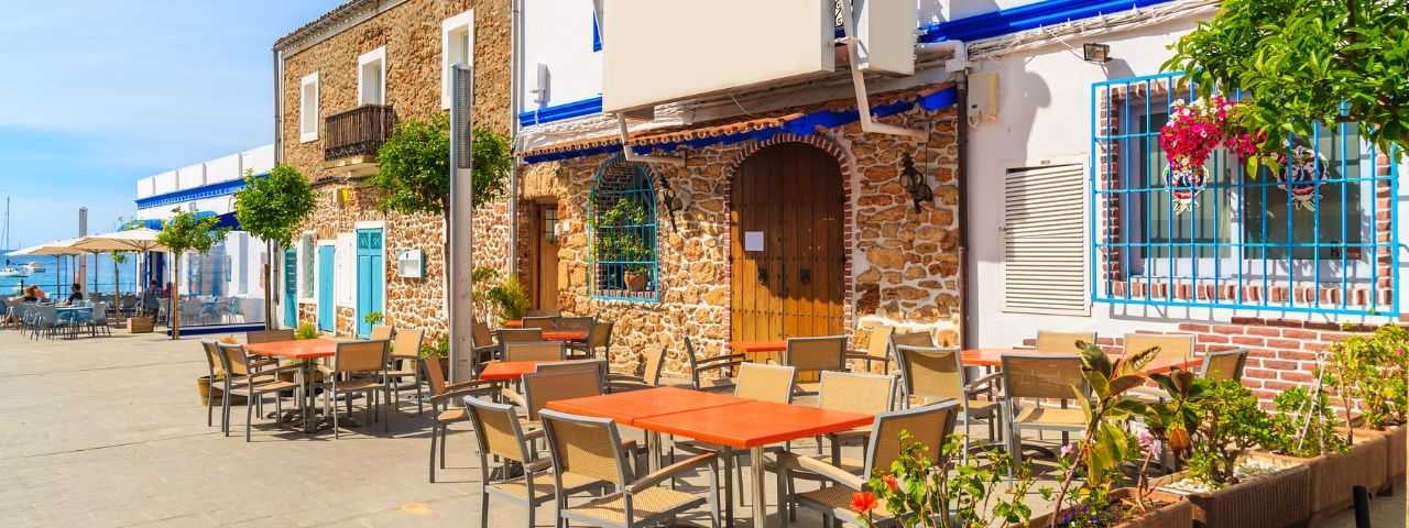 Restaurants and bars on a coastal promenade in Santa Eularia town, Ibiza island, Spain.