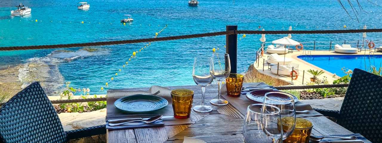 A photograph of a set table at a restaurant with a spectacular sea view in Mallorca, Spain.