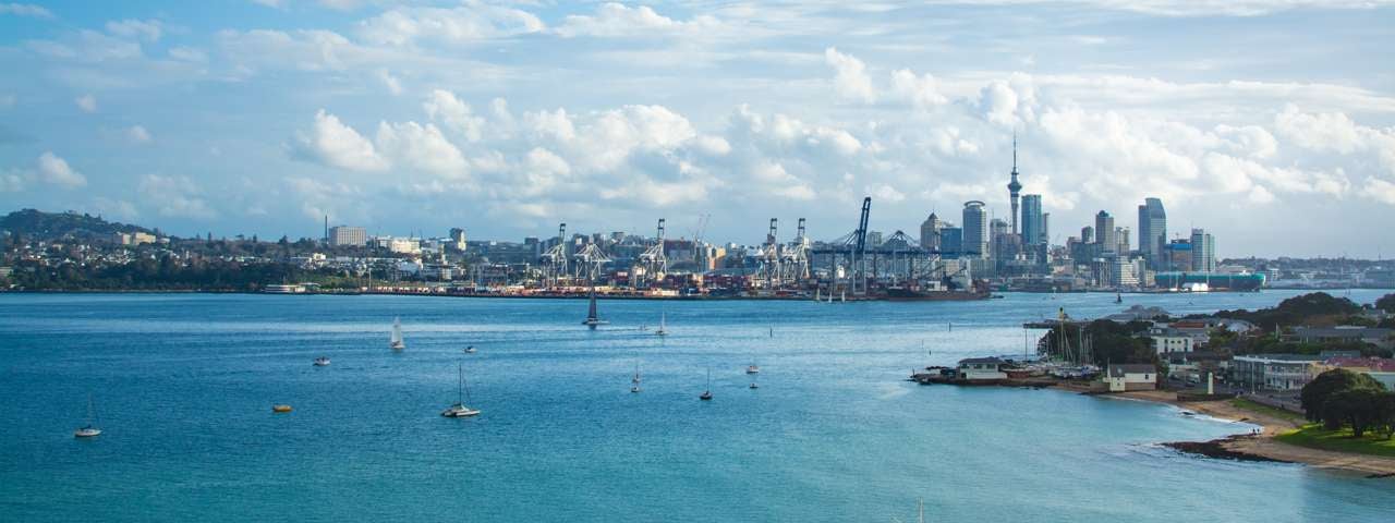 A distant view of Auckland from the harbour with the city skyline in the background.