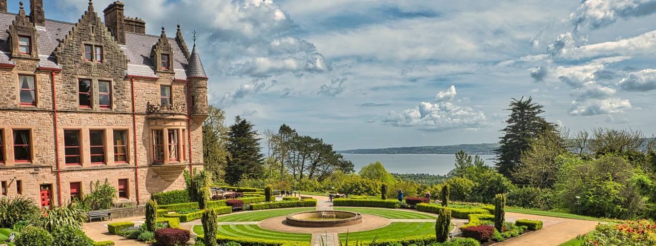 Belfast Castle overlooking a nearby lake.