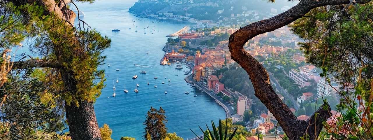 A view of a harbor village in the French Riviera with the sea in the foreground