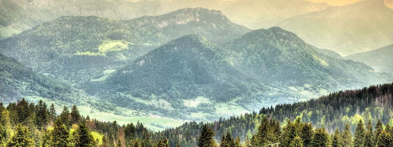 A view of the French Alps with mountainous landscapes bathed in sunlight close to Chambéry, France.