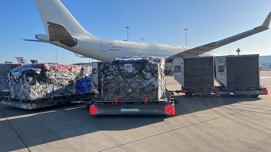 Two pallets with supplies waiting to be loaded onto a plane.