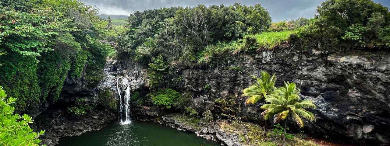 A waterfall surrounded by greenery in Haleakalā National Park, Hawaii. 