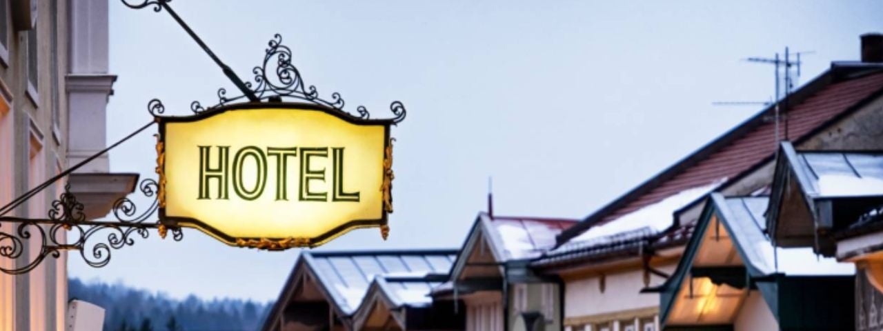 An antique hotel sign outside a hotel in Germany.