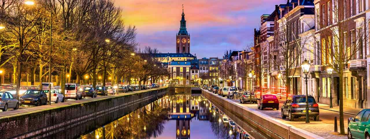 Traditional houses alongside a canal at sunset in The Hague.