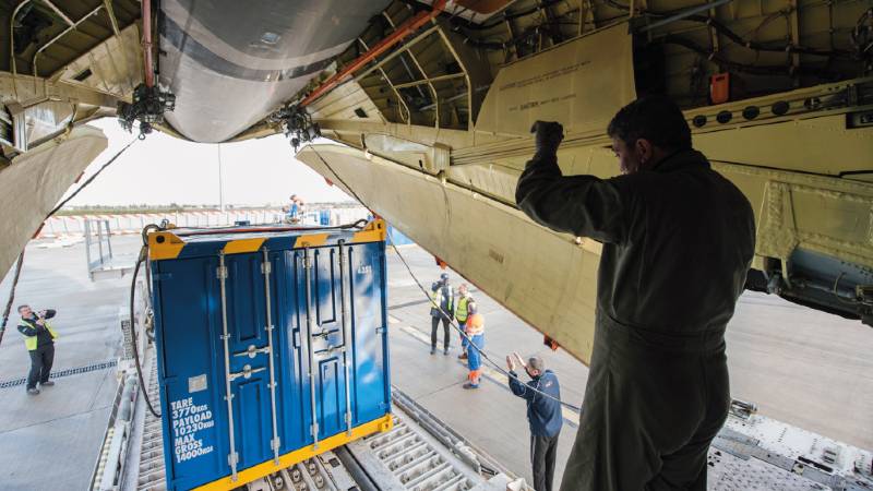 A cargo aircraft with freight being loaded.