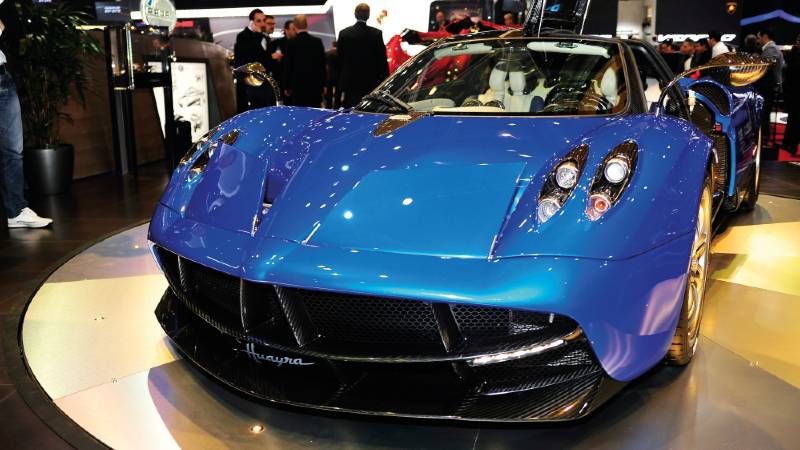 A stylish blue car in a showroom.