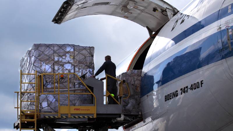 A worker loads cargo into a Boeing 747-400 F.