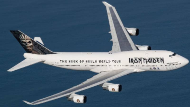 The Iron Maiden private tour jet flying over an ocean.