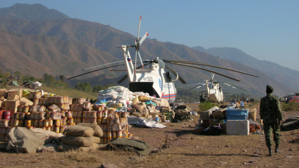 A grounded aircraft surrounded by humanitarian aid