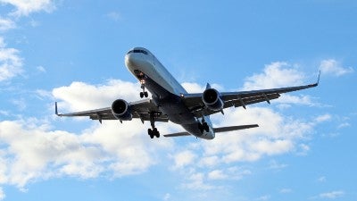 A large aircraft with dark clouds in the background.